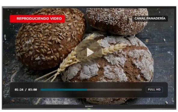 Pantalla de panadería reproduciendo un video de panes artesanales